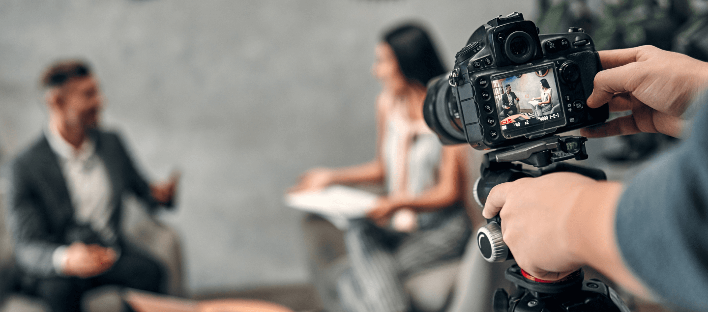 focus image captured over the shoulder of a person using a digital camera to film an interview.