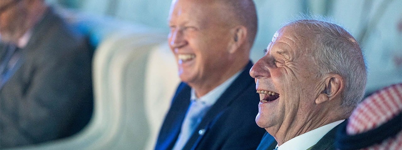 photo of a laughing man at a conference