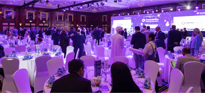Attendees mingling in a lavishly decorated banquet hall